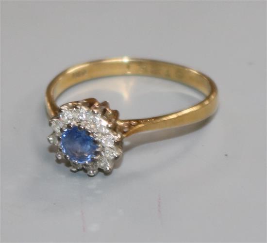 A 9ct gold, sapphire and diamond circular cluster ring, size L.
